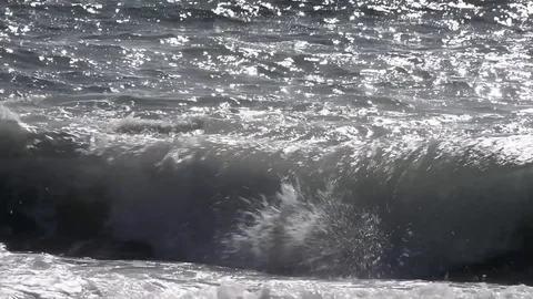 The sea moved by the strong wind crashes with strong waves on the beach Stock Footage 84024457