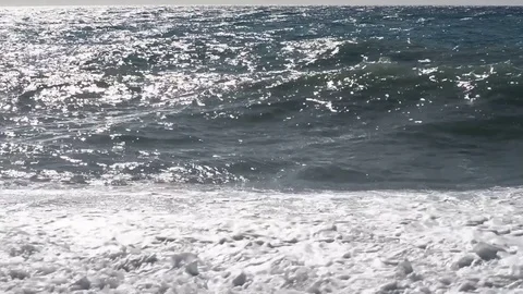The sea moved by the strong wind crashes with strong waves on the beach Stock Footage 84026764