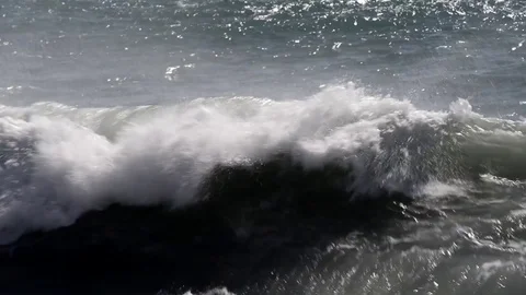 The sea moved by the strong wind crashes with strong waves on the beach Stock Footage 84028745