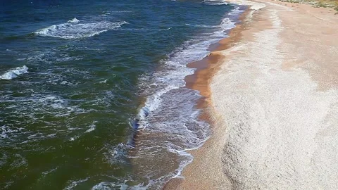 Sea or ocean, surf on a sandy beach with rocks Stock-Footage 138254545