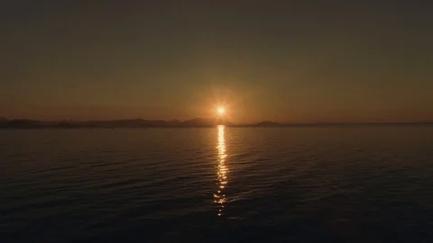Sea or ocean surface at sunset with beautiful sun reflection.. Aerial, drone Stock Footage 122454499
