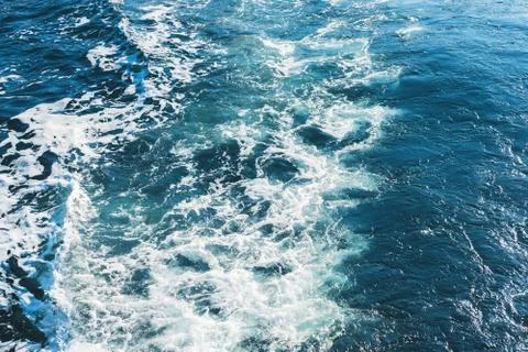 Sea or ocean waves surface texture. Abstract summer blue water background with Stock Photos