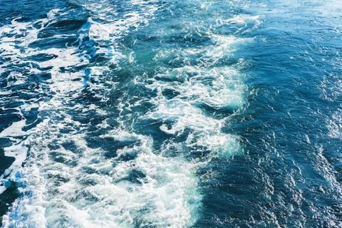 Sea or ocean waves surface texture. Abstract summer blue water background with Stock Photos