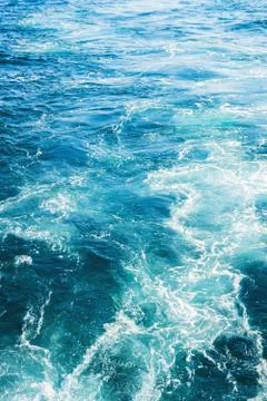 Sea or ocean waves surface texture. Abstract summer blue water background with Stock Photos
