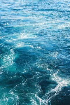 Sea or ocean waves surface texture. Abstract summer blue water background with Stock Photos