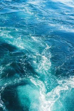 Sea or ocean waves surface texture. Abstract summer blue water background with Stock Photos