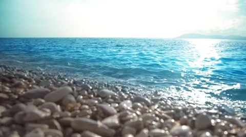 Sea, peeble shore and waves. Seascape at sunset. Video stock 64091272
