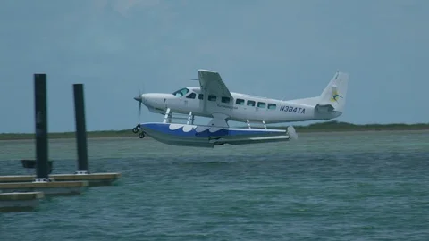 Sea Plane Flies Through Sky Landing On Water Stock Footage 100535004