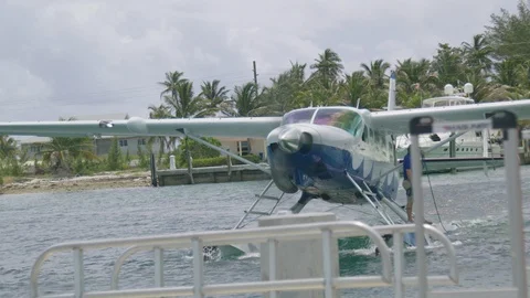 Sea Plane Pulls Up To Dock On Water Slow Motion Stock Footage 100536569