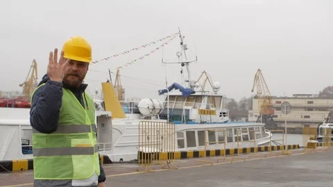 Sea port worker with a beard and a helmet Stock Footage 99352109