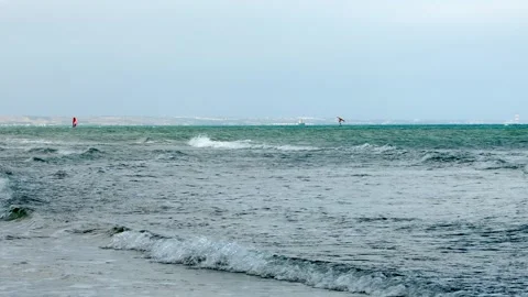 The sea rages in the background Windsurfer Stock Footage 242918798