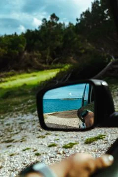 Sea reflection in car rear mirror. road trip Stock Photos