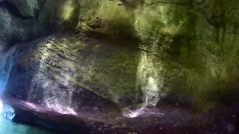 Sea reflects the light on a wall in a cave Stock Footage 79219371
