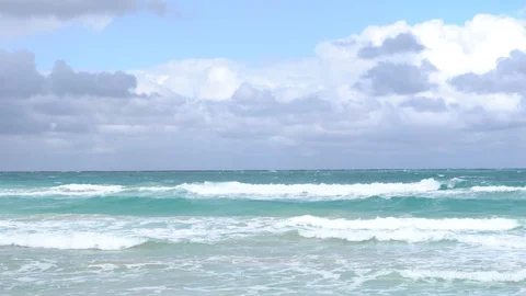 The sea is relatively calm with small waves 스톡 동영상 128407497