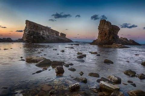 Sea rocks at sunset Stock Photos