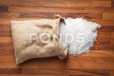 Sea salt in jute sack Stock Photos