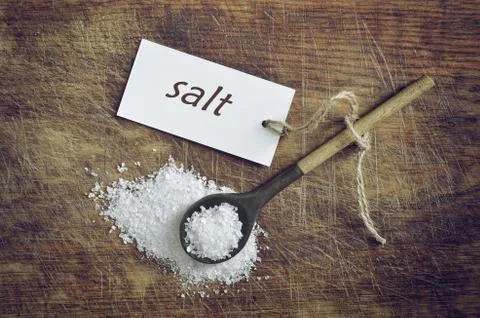 Sea salt in a rustic spoon Stock Photos