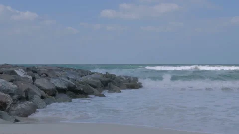 The sea sandy shore with splashes of waves on the rocks Stock Footage 85967341