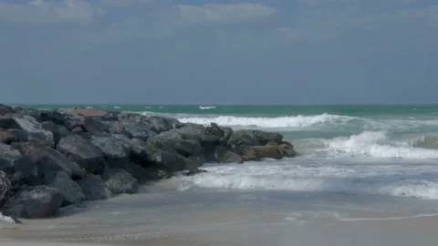 The sea sandy shore with splashes of waves on the rocks Stock-Footage 86005171