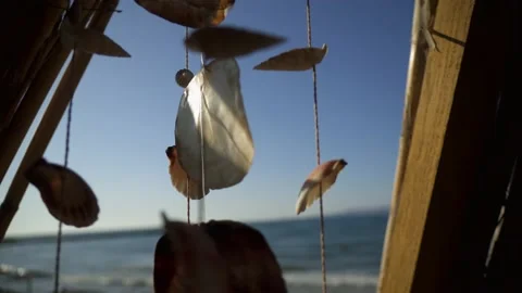 Sea Shell Wind Chime On The Sea Shore and Blue Sky Stock Footage 172376218