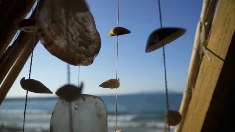 Sea Shell Wind Chime On The Sea Shore and Blue Sky Stock Footage 172378191