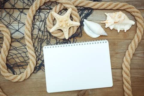 Sea shells, notepad and rope on old boards Fotos Stock