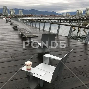 Sea side chairs on dock Stock Photos