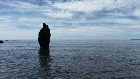Sea Stack and Calm Sea at Ballydwan Beach Waterford Ireland Stock Footage 337396422