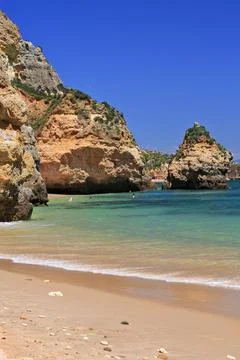 Sea stack and cliffs-northernmost end of Praia do Camilo Beach. Lagos-PT Stock Photos