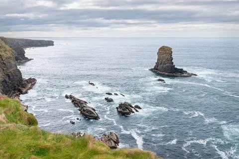 A Sea Stack and the north coast cliffs of the loophead peninsular Stock Photos