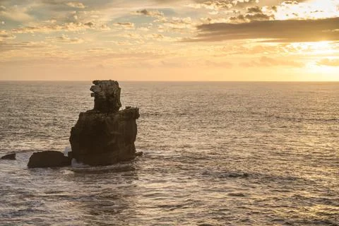 Sea stack in Atlantic ocean at sunset near Peniche Stock Photos