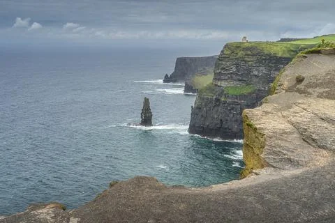 Sea stack next to Obrians Tower on iconic Cliffs of Moher, Ireland Stock Photos