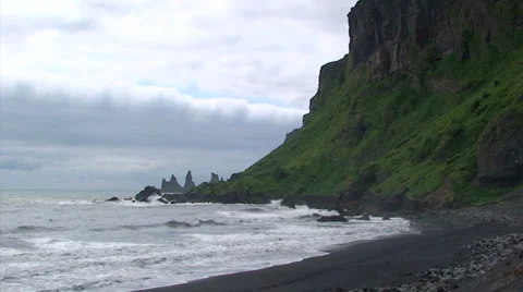 Sea stack pinnacles and cliff from volcanic beach Stock Footage 37588151