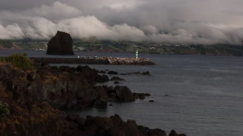 Sea Stack in Shadow. Atlanticoline Ferry coming into Port. Stock Footage 238404134