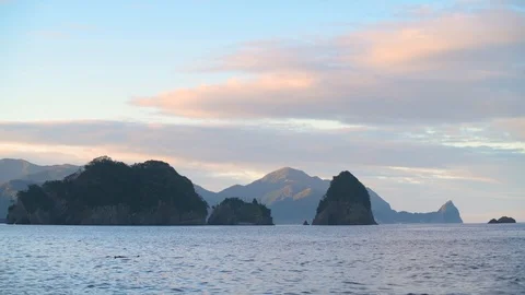 Sea stack at sunrise on a quite summer morning, Izu Peninsula, Japan Stock Footage 118485331