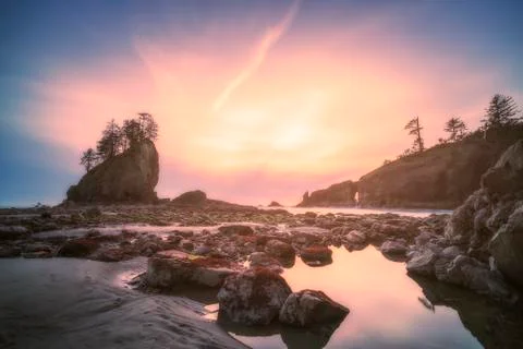 Sea stack in sunset time with blue and purple light,scenic view of second bea Stock Photos