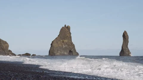 Sea stacks in ocean off black beach Stock Footage 226313668