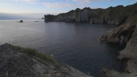 Sea stacks at sunset on a cloudy summer day, Izu Peninsula, Japan Stock Footage 118485300