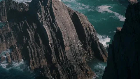 Sea stacks with white stork nests amid waves, Cabo Sardao, Portugal Stock-Footage 346479998