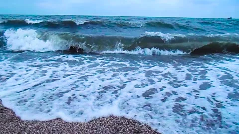 Sea storm, big waves on the sandy shore. View from the coast to the sea storm Stock Footage 137265814