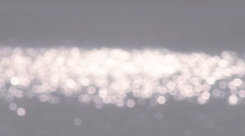 Sea of the sun specks on gray background. Water reflection. Stock Footage 40809692