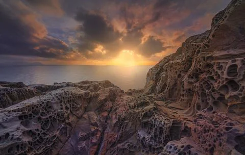 Sea at sunset and rocks eroded. Populonia, Buca delle Fate. Piombino, Maremma Stock Photos