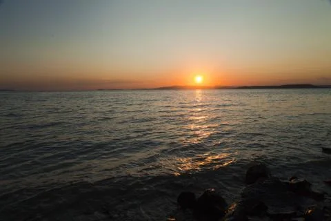 Sea at sunset Stock Photos