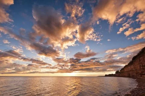 Sea at sunset, the sky is in beautiful dramatic color Stock Photos