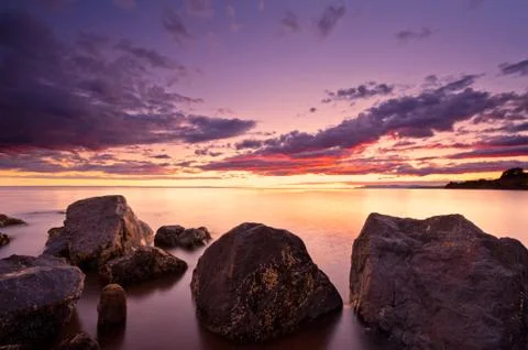 Sea at sunset, the sky is in beautiful dramatic color Stock Photos