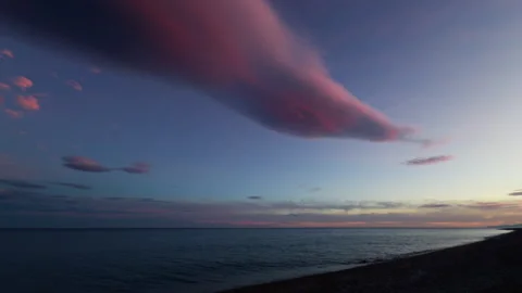 The sea at sunset with some pink clouds Stock Footage 261051532