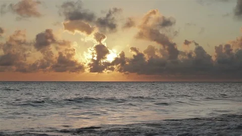 Sea surf on a background of beautiful clouds in the rays of the rising sun. Stock Footage 70818202