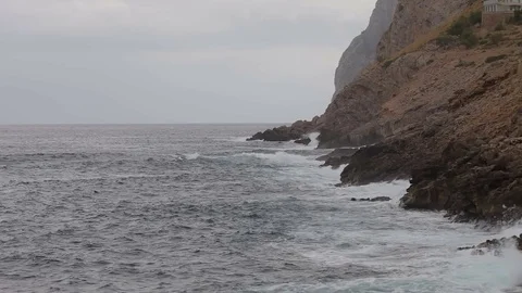 The sea surf in the bay on a cloudy day. A small storm. Polenca and Port Stock Footage 76490786