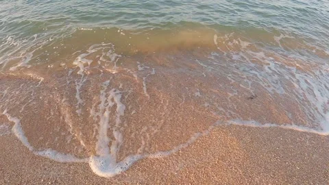 Sea surf on the beach at sunset close-up 스톡 동영상 246851016