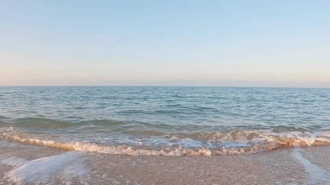 Sea surf on the beach at sunset close-up 動画素材 246851040
